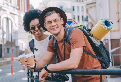happy-young-interracial-couple-of-travelers-with-paper-cups-of-coffee.jpg happy-young-interracial-couple-of-travelers-with-paper-cups-of-coffee.jpg
